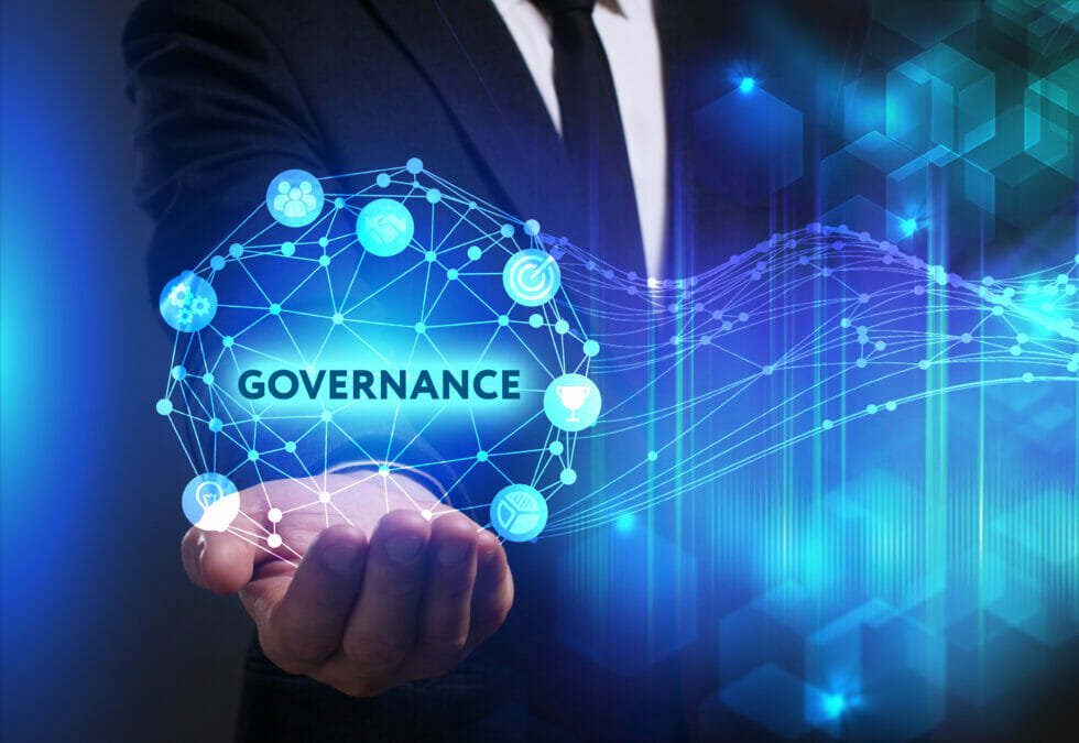 a hand holding a glowing network inside written Governance